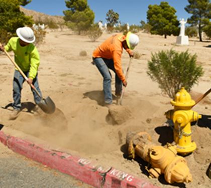 Workers placing a fire hydrant