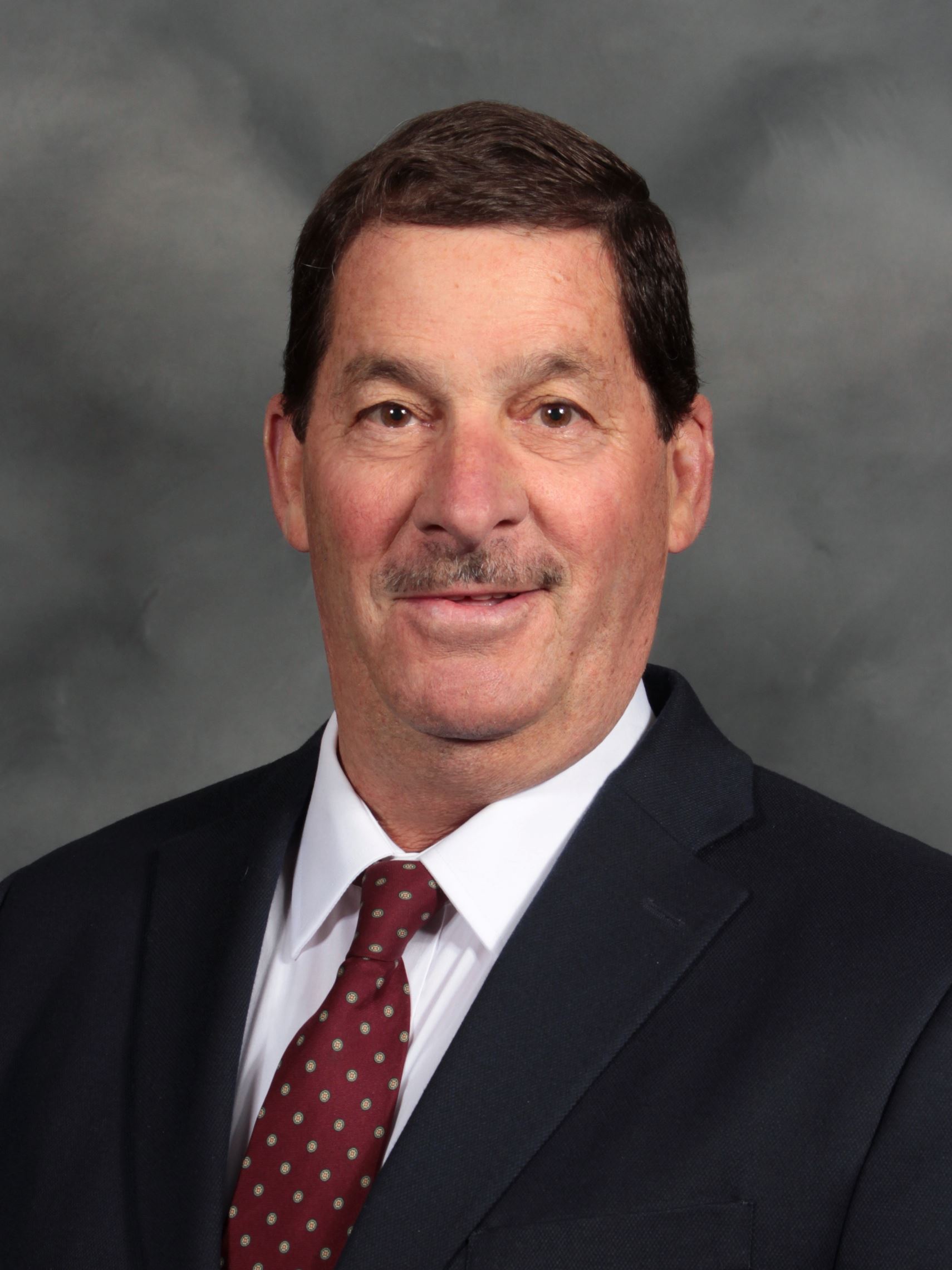 Man in a black suit with white shirt and red tie (jpg)